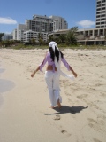 pregnant woman walking in the sand